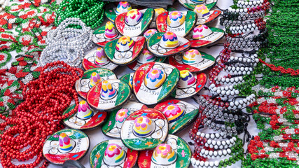 Wall Mural - A table full of colorful Mexican hats and bracelets. The hats are decorated with flowers and the bracelets are made of beads. Decoration to celebrate Independence Day in Mexico, zocalo