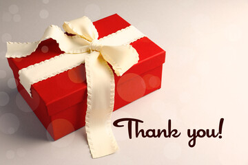 Wall Mural - Thank you card design with gift box on light background, bokeh effect
