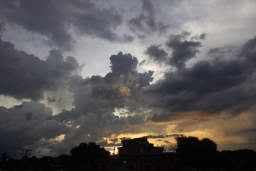 Wall Mural - Cloudscape, Colored Clouds at Sunset near the city 