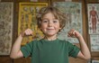 © tongpatong - A white boy's portrait with his arms flexed and smiling in front of anatomical posters