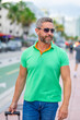 Mature man traveler outdoor. Tourist traveler on spring vacation. The travelers luggage for spring trip. Summer tour. A tropical getaway. Spring break. A traveler enjoys summer day. Summer trip.