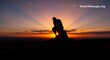 © Nature - World Philosophy Day silhouette of thinker sculpture with sunrise.