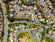 © Monet_P - Drone view of Californian desert suburb with red-tile rooftops and green backyards in the morning light