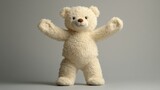 A fluffy, cream-colored teddy bear stands with arms outstretched against a neutral gray backdrop
