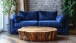 © Her - A stylish living room boasts a deep blue velvet couch and a rustic wooden coffee table.