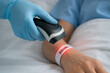 ©  BanuClick - A close-up image of a healthcare worker scanning a patient’s wristband using a barcode reader. The red light reflects accuracy in patient identification, hospital safety protocols, and digital record