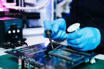 The technician repairing the motherboard in the lab with copy space. the concept of computer hardware, mobile phone, electronic, repairing, upgrade