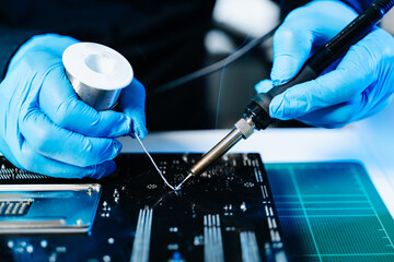 The technician repairing the motherboard in the lab with copy space. the concept of computer hardware, mobile phone, electronic, repairing, upgrade