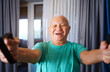 © TrueShot | Westend61 - Smiling senior exercising with resistance bands at home for fitness