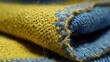 © Nurdin - Close-up of folded yellow and blue fabric, showing texture