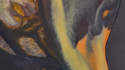 Wall Mural - Braided flowing river with volcanic sand and orange sediments. Icelandic landscape near. Coastline. Aerial top down shot.