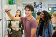 © Rido - Portrait of smart guy at whiteboard while solving problem equation