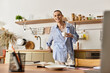 © Bliss - Young man enjoys coffee in a modern kitchen, exuding charm and style with a relaxed demeanor