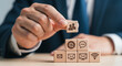 © Ruman - Photo of a businessman places a wooden block with people icons on a stack of blocks representing communication and technology