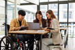 © David - Asian Male Manager On A Wheelchair Sitting With His Colleagues At Workplace