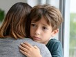 © Moopingz - A young boy with sad eyes embraces a woman from behind, seeking comfort and support in a close hug.