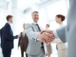 © Septiyani - Business partners shaking hands, demonstrating success and collaboration in the modern office