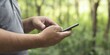 © chelmicky - Man using mobile phone connecting with nature