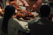 © Zamrznuti tonovi - Family celebrating thanksgiving, carving roasted turkey at home dinner table