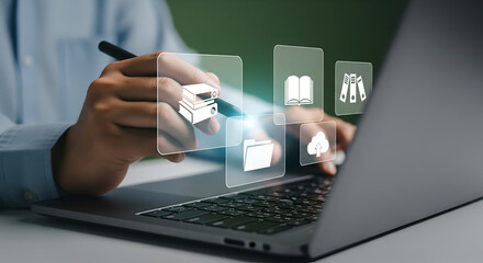 Person using a stylus on a transparent screen with digital icons over a laptop