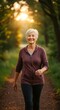 © Margarita Ratatosk - Happy elder woman walking on a nature trail at sunset. Active lifestyle and healthy aging concept.