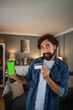 © Migma_Agency - Man showing credit card and smartphone for online payment concept