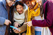 © Xavier Lorenzo - Multiracial friends laughing together watching social media content on phone. Technology and youth lifestyle concept