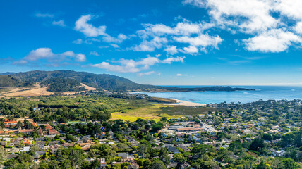 Wall Mural - aerial drone view of Carmel River State Beach with city and mountains