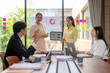 © Apichat - Businesswomen showing tablet with charts during office meeting