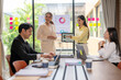 © Apichat - Businesswomen showing pie chart on tablet during office meeting