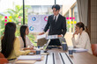 © Apichat - Businessman showing charts during office meeting with coworkers