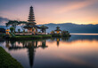 © tuelekza - Pura Ulun Danu Beratan, the majestic floating Hindu temple on Lake Beratan, Bedugul, Bali, Indonesia, beautifully reflected against the vibrant colors of sunset/sunrise.