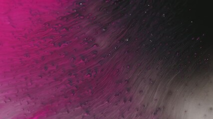 Wall Mural - Ink drip. Color liquid. Defocused pink sparkling water flow splash dark black texture on abstract acrylic creative background.