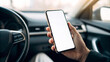 © Anatoli - Person holding smartphone in modern car interior during daytime, focused on screen