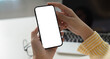 © wichayada - Mobile Technology. Person holding smartphone with blank screen for digital content creation.
