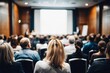 © Irtiko - Engaging conference presentation with diverse audience listening attentively in a modern auditorium, perfect for illustrating corporate training or a business seminar event