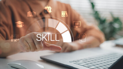Wall Mural - hand pointing at virtual skill development icon on laptop screen, symbolizing online learning, digit