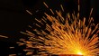 © Sky - Industrial scene with glowing orange sparks in motion against dark background, metalworking abstraction.
