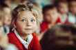 © OneLoveOnePhoto - Little girl at school with blonde hair.