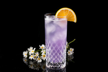 Wall Mural - An assortment of cold beverages with lemon and ice, including a cocktail and glasses of water, isolated on a white background