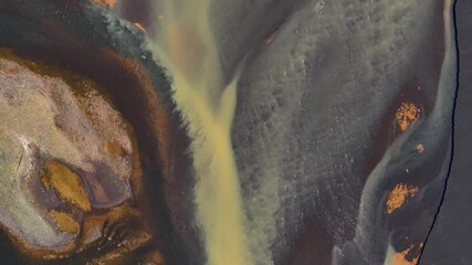 Wall Mural - Braided River in different colors on Iceland island. Aerial top down shot. Volcanic island with erosion sediments, mud and sand. Flyover shot.
