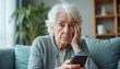 © Vadym - Stressed elderly senior woman looks confused with smartphone. Frustrated lady has problems with online payments and banking. Senior citizen faces internet fraud or cyber scam on phone.