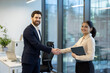 © Liubomir - Business professionals sealing a deal with a firm handshake in a modern office, symbolizing partnership, trust, successful negotiation, teamwork and new corporate opportunity