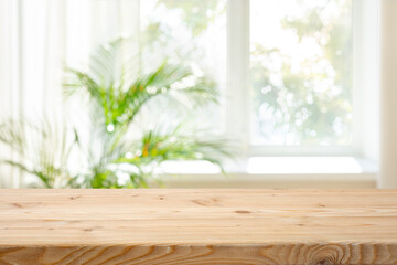 Wall Mural - Empty wood table top on blurred curtained window and abstract greenery from garden background
