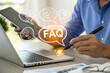 © Mr Cudling Pong - Person using smartphone and laptop with faq and question mark icons