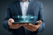 © britaseifert - AI interface emerging from a tablet held by a business user, showing holographic communication, network flow lines, and speech recognition modules with glowing highlights