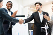 © PINA - business handshake for welcoming teamwork to meeting collaboration agreement in financial office, with colleague partner clapping hands to celebrate successful partnership and business deal
