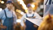 © Justlight - Focused shot on a clipboard with poultry inventory details capturing efficient order handling while the team discusses logistics in the blurry background.