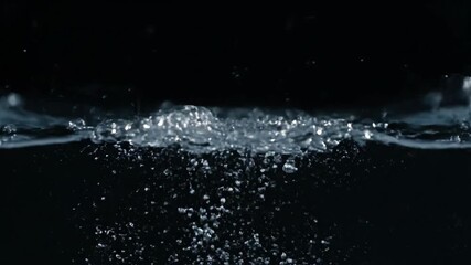 Wall Mural - Dynamic Close-Up of Clear Water Splashing and Swirling, Creating Intricate Patterns and Bubbles in Slow Motion on a Dark Background splashing, shape, ripples