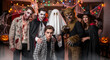 © MrLynx - Group of teens in horror costumes posing indoors on Halloween night